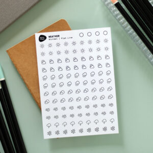 Product Fotografie Weersomstandigheden stickervel - Minimalistische stijl op creatief bureau met schetsboek, planner en potloden